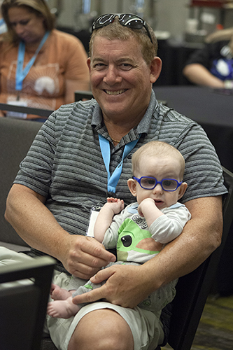 Father holding a young child.