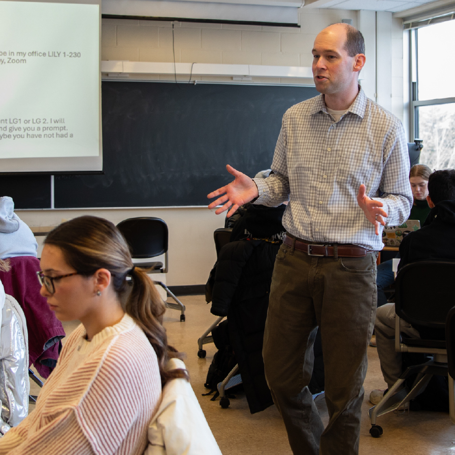 Professor Jacob Adler teaching students in a classroom